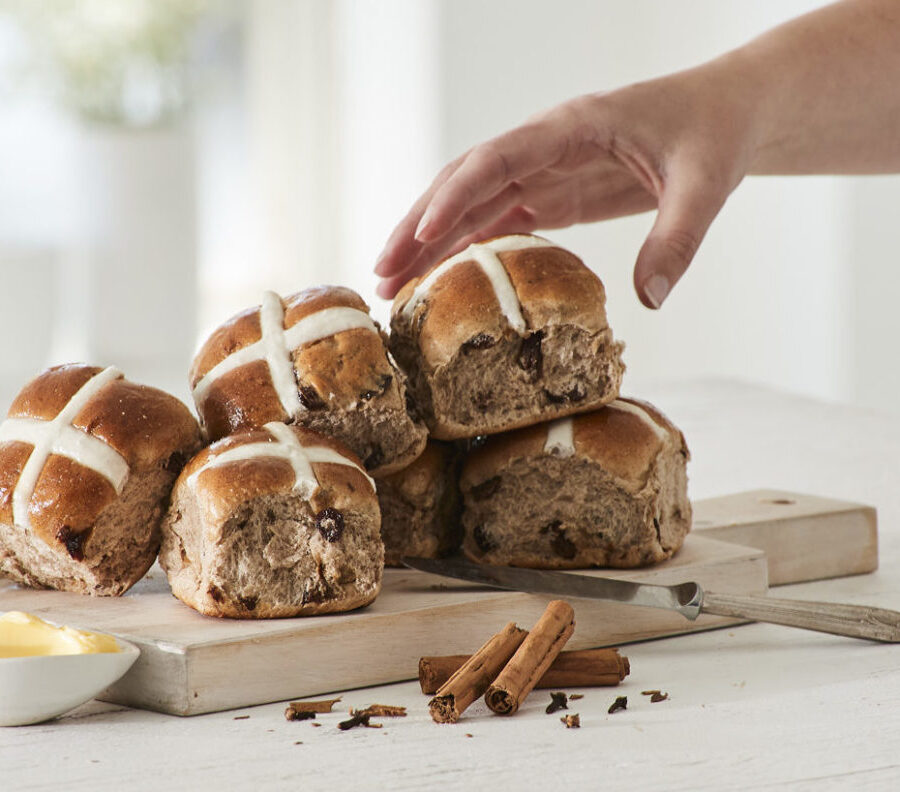 hand grabbing hot cross buns